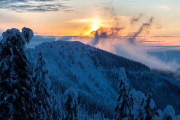Spectacular sunset over Mount Polonynka with couloirs between spruce forest covered with snow, winter in the Carpathians