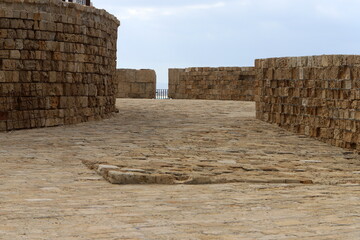 Stone wall of an ancient fortress on the seashore in Israel.