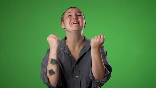 Angry, scared young gender fluid non binary woman 20s put hands on head screaming crying ask why me, isolated on green screen background studio. Slow motion