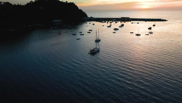 Aerial circle drone view of yacht parking in Sestri Levante harbor, Italy.