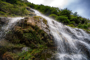 Beautiful waterfall along the trail at Tiger Leaping Gorge, Yunnan, China.