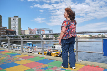 Mature latin woman enjoying a sunny summer day at the tourist neighborhood of La Boca, in Buenos...