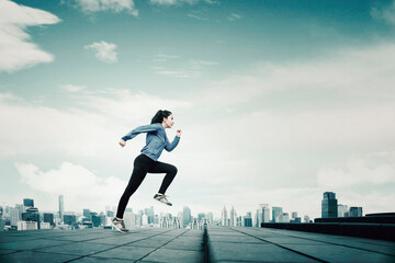 Low angle view of young woman running on stairs