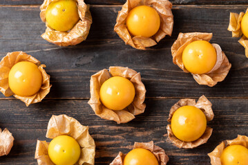 Cape gooseberry or golden berry (Physalis peruviana) on wooden background, Table top view