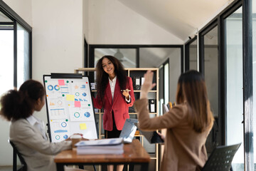 Asian business workgroup designers team with asian woman leader discuss paperwork financial report statistical data, forecasting working on common project. Brainstorm, briefing activity concept