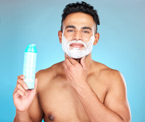 Face, skincare and man with shaving cream product in studio isolated on a blue background. Beauty,...