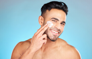 Cream, face and skincare man in studio for beauty, cosmetics and product promotion mockup with smile happy for benefits. Skin care, dermatology and young model with sunscreen application in portrait