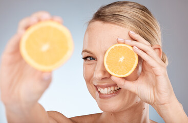 Skincare, beauty and orange for woman as natural facial with citrus and vitamin c fruit for health and wellness on studio background. Portrait, face and smile of Canada model for organic dermatology