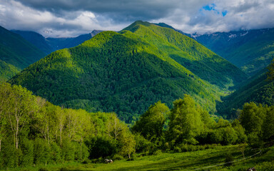 View on the Lez river valley with snow covered peaks in the background on a beautiful summer day in...