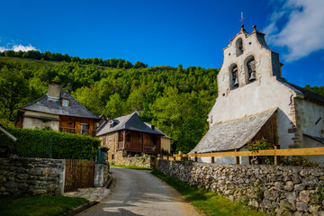 Fototapeta na wymiar View on the old church and traditional houses in the village of Antras in the French Pyrenees mountains range