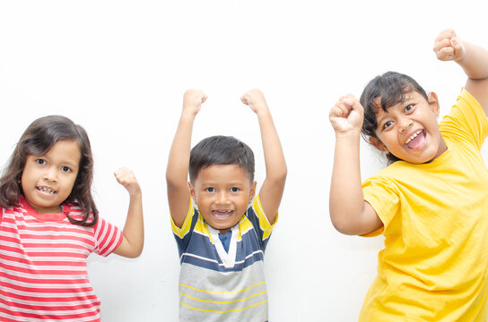 Multi Racial Of Asian Little Kids Showing Expression Of Happines And Over Joy With Hand Fist Raising Showing Strength And Growth