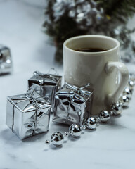 Christmas decorations on the table with a cup of coffee and an alarm clock. Christmas background. Merry Christmas greeting card, frame, banner. Space for text. Selective focus.