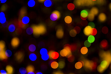 Colorful abstract bokeh lights Christmas background for your design.