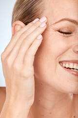 Woman hand, face and skincare glow on studio background in anti aging wellness, wrinkles management...