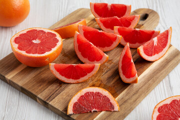Organic Red Ruby Grapefruit on a Wooden Board, side view.
