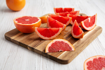 Organic Red Ruby Grapefruit on a Wooden Board, low angle view. Close-up.