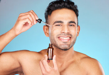 Skincare, health and portrait of man with serum on face for anti aging and glowing skin on blue...