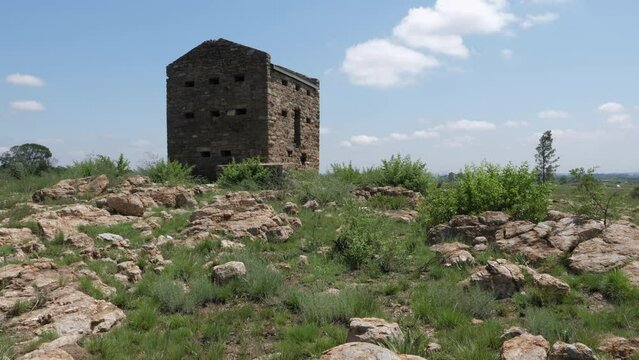 Fortified stone blockhouse from Boer War stands alone on rocky hill