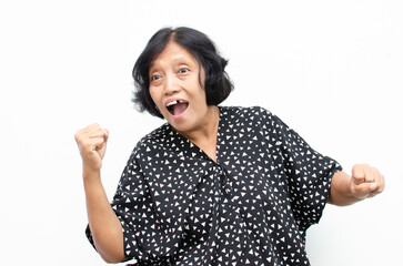 Portrait of happy ecstatic senior asian woman making yes winning gesture with raising her fist...