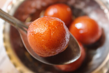 Indian sweet food Gulab Jamun served in a steel bowl. indian sweet gulab jamun closeup view