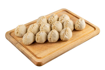 Raw dumplings on a wooden cutting board close-up of a plate. Russian kitchen. Isolated image.