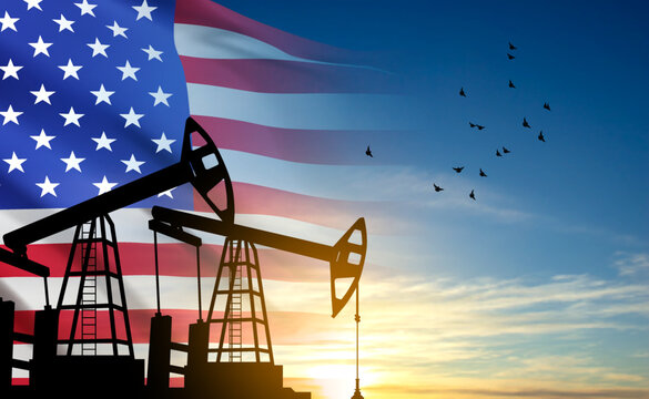 Silhouette of Oil pump. Industrial machine for petroleum on background of sunset. USA Oil Industry concept