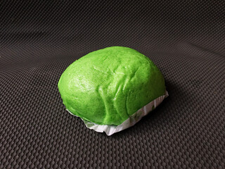 Green Bakpao.Asian steamed buns on wooden oval tray