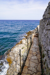 cobblestone pathway coast beach mediterranean sea in south Antibes Juan-les-Pins France
