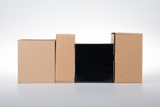 Stack of cardboard boxes black brown box of different sizes on white background