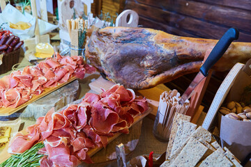 Assortment of various kinds of smoked or dried sausages. Meat products for table decoration in a restaurant