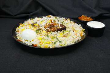 Chicken Biriyani on black round plate