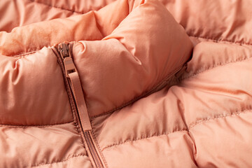 Close up of padded coat with zipper. Pink parca texture