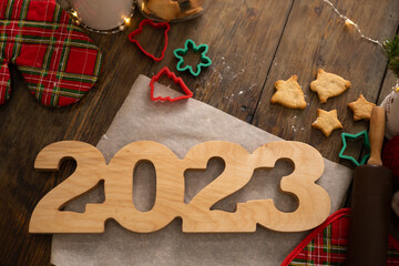 NEW year merry Christmas and happy holiday Christmas cookies wooden numbers 2023 on a dark wooden background eco-friendly general plan place for text