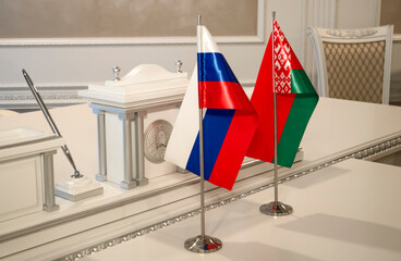 Flag of Belarus and Russia, a table for signing documents.  Meeting of state delegations, signing of documents.
