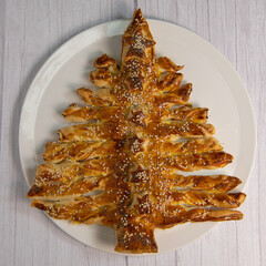 Christmas tree recipe with puff pastry, smoked salmon and garlic and herb cheese. High quality photo
