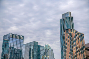 Skyline of downtown Austin Texas against sky covered with clouds background