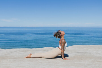 Upward Facing Dog Urdvha Mukha Svanasana yoga on the beach