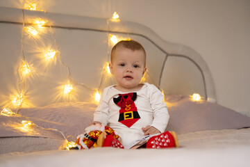 cute Boy holding in his hands a New Year's garland for Christmas
