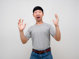 Asian man grey shirt standing gesture amazed feels shocked isolated