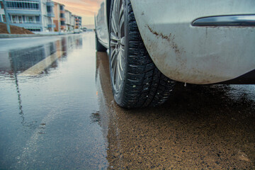 rainy weather, wet road and car wheel. concept of driving on wet road.