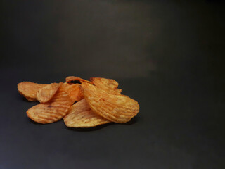 photo of potato chips with black background