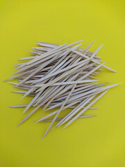 lots of toothpicks on a yellow background