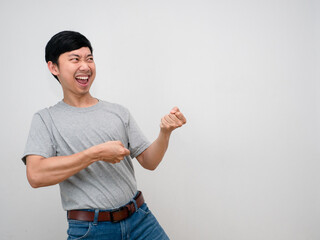 Asian man grey shirt smile gesture pull rope heavy copy space