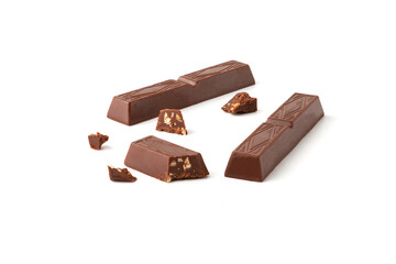 Pieces of milk chocolate isolated on white background.
