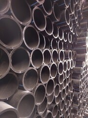 The stack of HDPE (high density polyethylene) pipes shot close up inside the warehouse