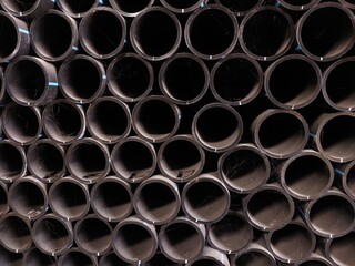 The stack of HDPE (high density polyethylene) pipes shot close up inside the warehouse