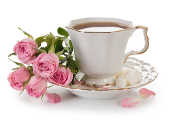 Tea in a white porcelain cup and a bouquet of roses isolated on a white background