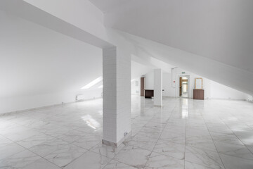 Spacious empty hollow attic with tiled floor