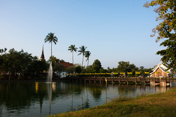 Fototapeta na wymiar View landscape water pond garden park and Wat Traphang Thong on island with cityscape old town for thai people foreign travelers travel visit in morning time at Sukhothai Historical Park in Thailand
