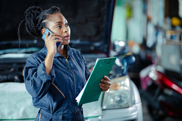 Car service Garage staff worker contact customer call talking replace auto part list and price - Powered by Adobe